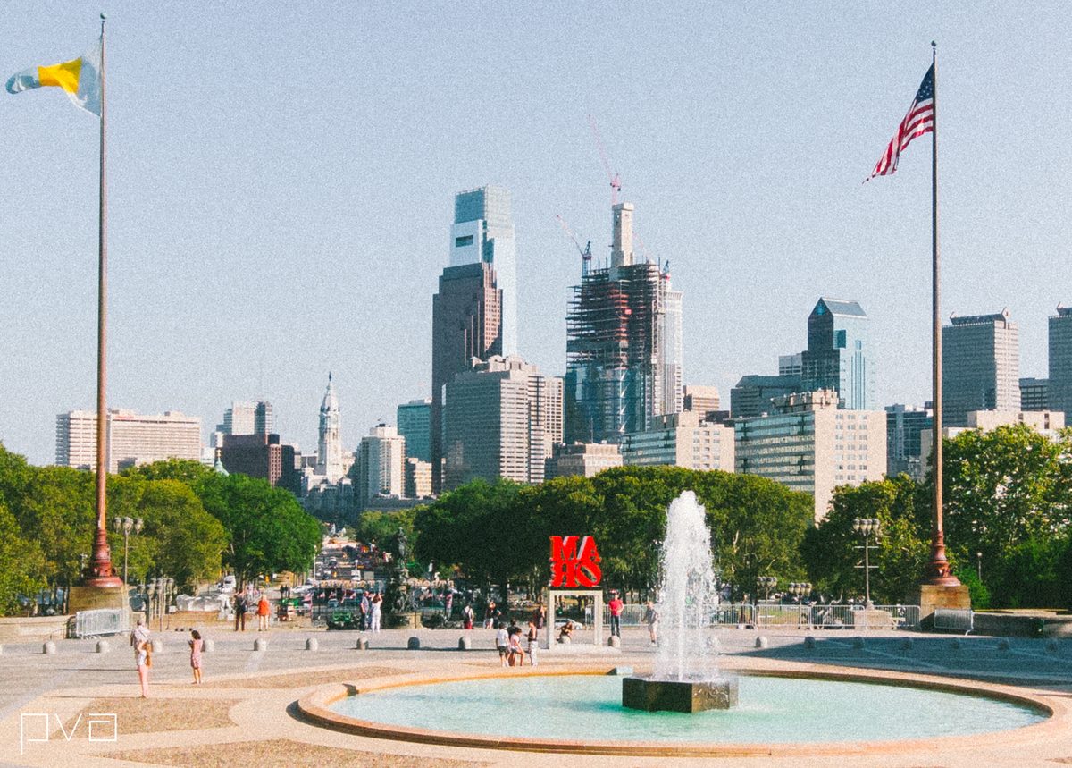 The view down the parkway from the Art Museum steps, fountain playing and the skyline hazy behind.