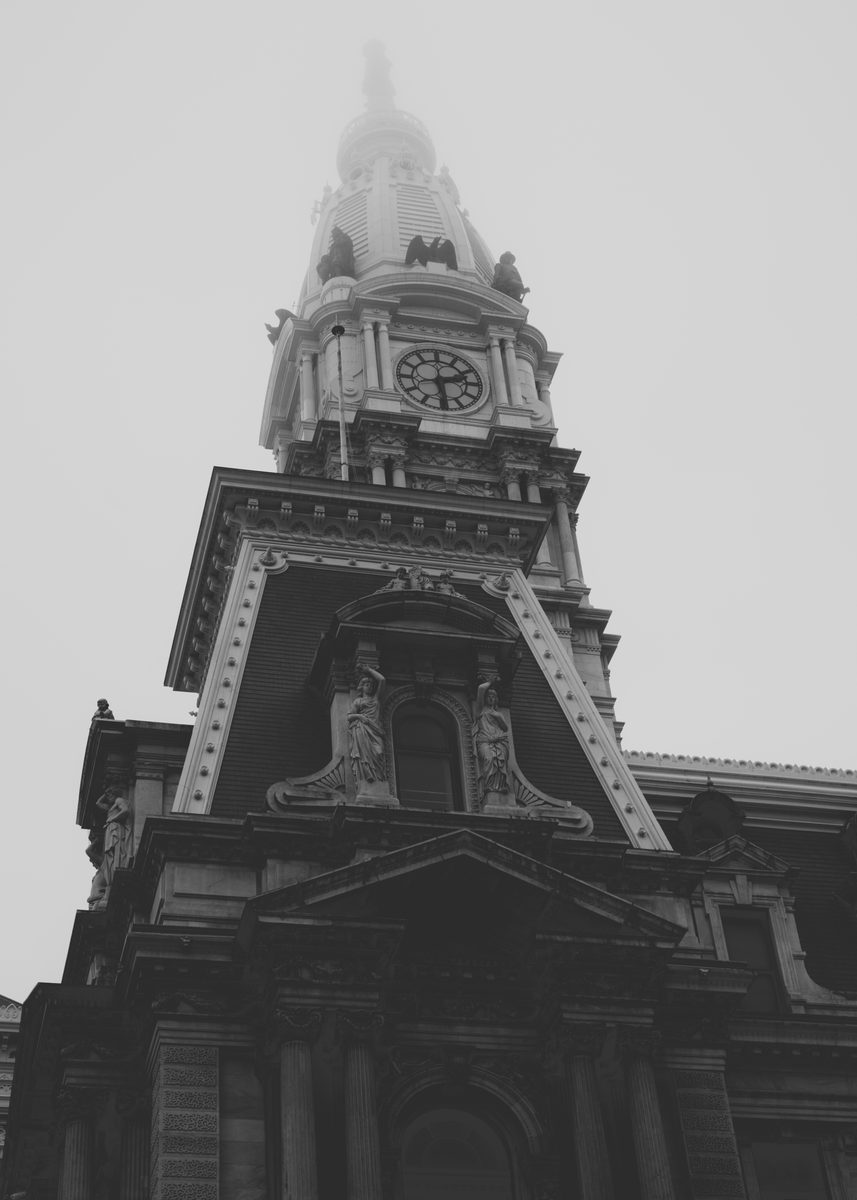Philadelphia City Hall from directly below in fog, the caryatids and clock tower washed flat, in black and white.
